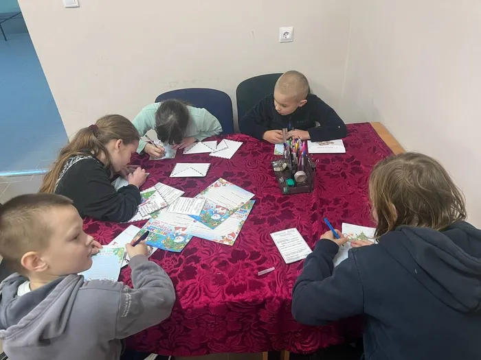 на фотографии ребята пишут письма Деду Морозу